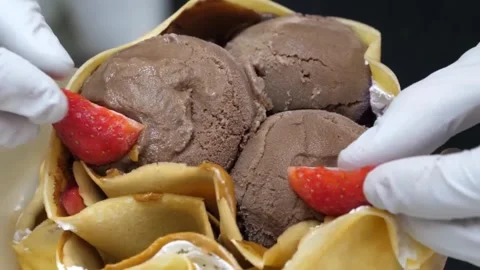 Gloved Hands Adding Fresh Strawberries to Chocolate Ice Cream Crepe Dessert 스톡 동영상 345692396