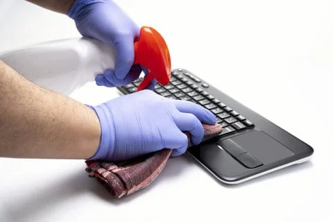 Gloved hands cleaning computer keyboard on white background Stock Photos