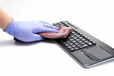 Gloved hands cleaning computer keyboard on white background Stock Photos