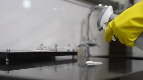 Gloved hands disinfecting sink surface in bathroom Stock Footage 148111927
