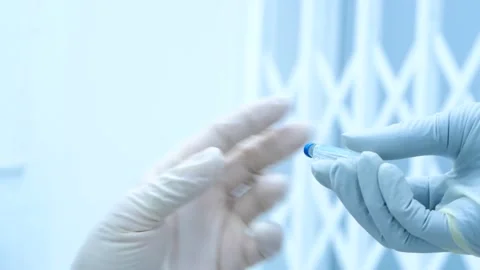 Gloved hands of doctors, surgically transferring instruments, needles and Video stock 145602657