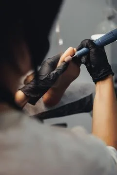 Gloved hands gently hold a delicate tool Stock Photos