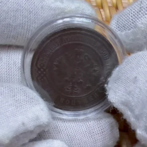 Gloved hands holding a 3 kopecks coin in a protective case. Russian Empire. Stock Footage 325540699