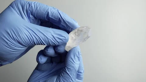 Gloved Hands Inspecting Clear Crystal Mineral Specimen Video stock 346410301