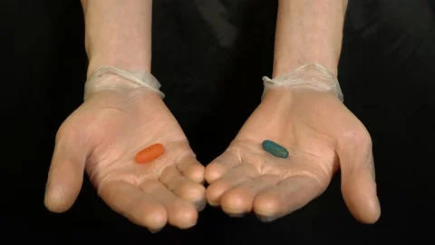 Gloved hands offer a pill Video stock 130906397