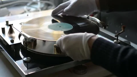Gloved hands placing a records on a high-end vintage turntable Stock Footage 263543165