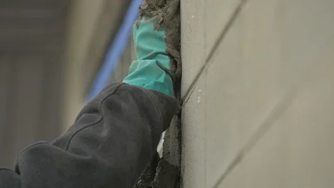 Gloved Hands Pushing Cement Into Cracks Stock Footage 100693117
