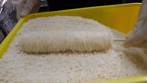 Gloved Hands Rolling Korean Corn Dog in Panko Breadcrumbs, Slow Motion Video stock 343587670