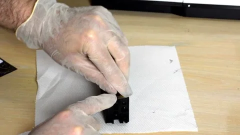 Gloved Hands Set Microelement onto Cartridge on White Towel Surface Stock Footage 323075826