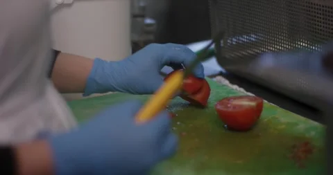 Gloved Hands Slicing Fresh Tomato in Commercial Kitchen, Close Up Shot Stock Footage 340365673