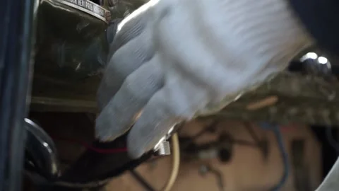 Gloved hands start the car Stock Footage 145427947