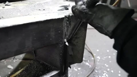Gloved hands working along the edge of a sand casting mold box at a foundry Stock Footage 343370541