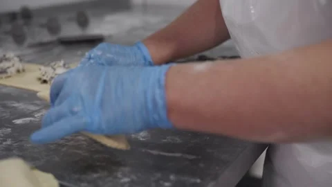 Gloved Hands Wrapping Meat in Puff Pastry. Bakery production Stock Footage 321691858