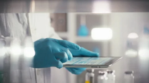 A gloved healthcare worker precisely controls a digital tablet. Providing op Stock Footage 331452263