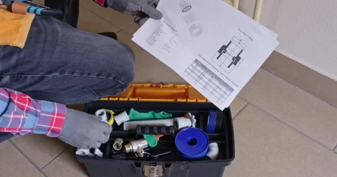 Gloved installer points datasheet and confirms assembly order Stock Footage 322009857