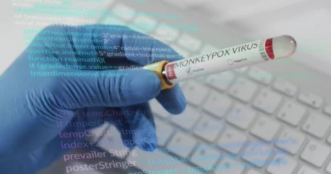 Gloved lab hand entering lifting monkeypox tube showing positive result as code Stock Footage 317793100