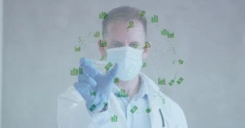 Gloved male doctor tapping green holo charts, adjusting icons then presenting 库存照片