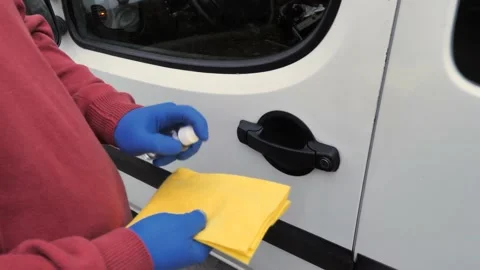 A gloved man opens a car door Stock Footage 130896084