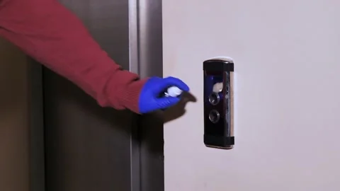 Gloved man presses the elevator call button Stock Footage 130895999