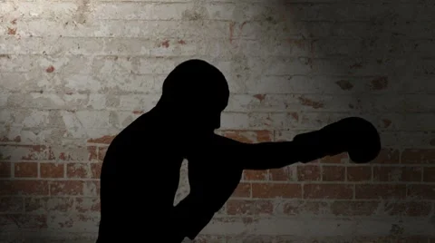 Gloved Shadow Boxing Silhouette Against Brick Wall Stock Footage 8777534