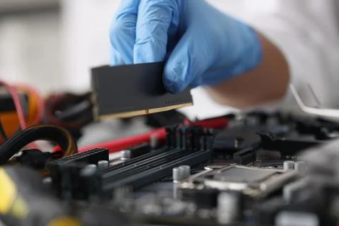 Gloved technician diagnoses broken computer equipment closeup Stock-Fotos