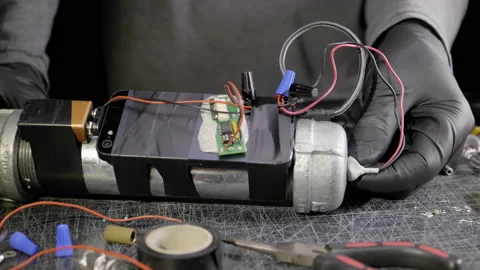 GLOVED TERRORIST COMPLETES A PIPE BOMB.  4K SLIDER SHOT. Stock Footage 163560544