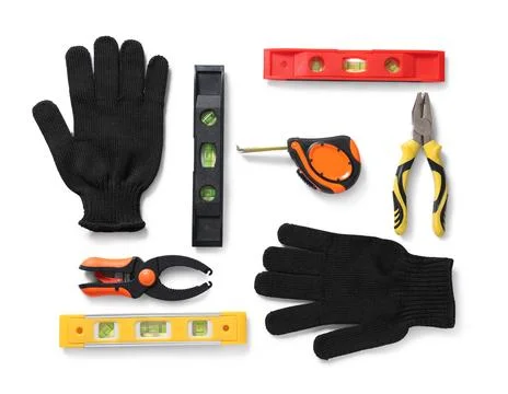Gloves and different construction tools isolated on white background Stock Photos