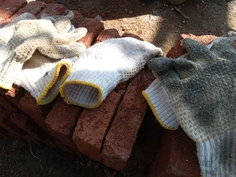 Gloves on red stone, object Stockfoto's