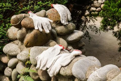 Gloves workers were left on a stone wall. Stock Photos