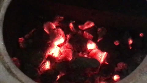 Glow Of Coals Smolder with a Flame of fire in Dark Circle of a Stove Hole 4 Stock Footage 168014064