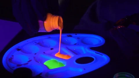 Glow in the Dark Neon Acrylic Paint under Ultra Violet Blacklight in Slow Motion Stock Footage