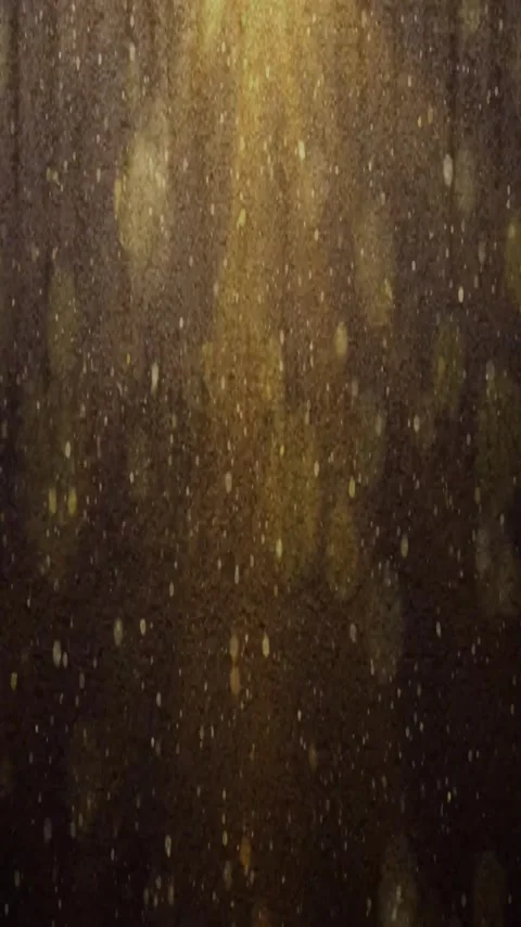 Glow Particles Falling in Light Rays 4K Bokeh Background with Shiny Lights Video stock 283411503