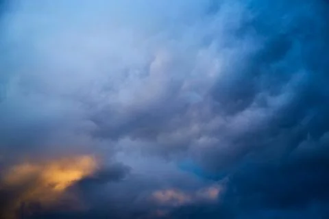 Glow through dark clouds, light among clouds Stock Photos