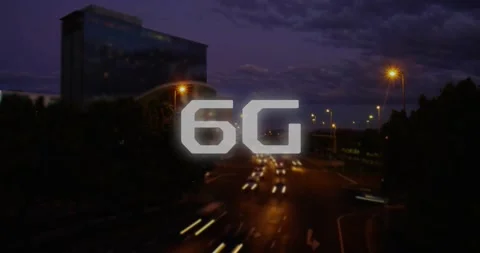 Glowing 6G text animation over busy city street during nighttime Stock Footage 330725396