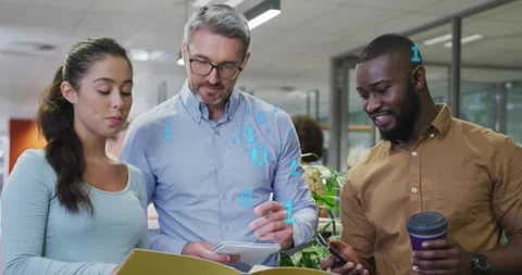 Glowing binary animating over torsos urging tech team reviewing documents noting Video stock 317128640