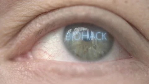 Glowing BIOHACK text on the eye. Biohacking related macro shot Stock Footage 131388884