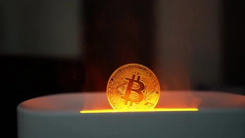 Glowing Bitcoin Coin Emerging from Container, A glowing Bitcoin coin emergi.. Vídeos de archivo 304876609
