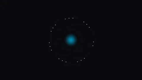 A glowing blue atomic nucleus surrounded by a ring of small white particles Stock Footage 339617641
