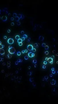 Glowing blue bubbles floating against a dark black background at night 스톡 일러스트