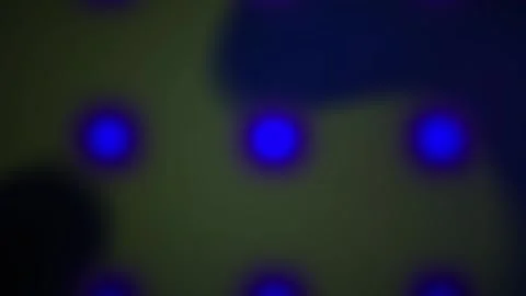 Glowing blue dots on dark background with greenish hue. Stock Footage 336695386