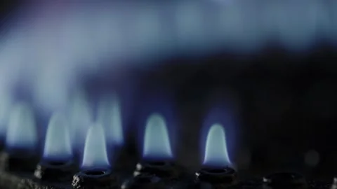 Glowing blue flames on a kitchen stove in extreme close-up Stock Footage 301666038