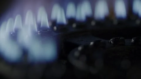 Glowing blue flames on a kitchen stove in extreme close-up Stock Footage 301666537
