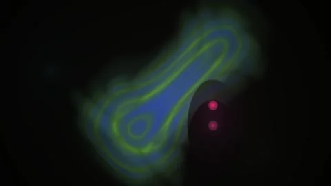 Glowing blue green oval shaped object with red dots. Stock Footage 336695476