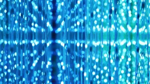 Glowing blue light dots creating abstract futurism and technology pattern bokeh Stock Photos