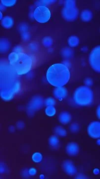Glowing blue spheres float in a dark abstract space, resembling molecules o.. Stock Illustration