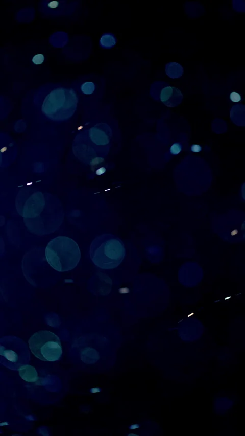 Glowing bokeh particles float darkly Stock Footage 345477913