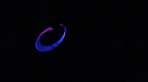Glowing bracelet whirls in the dark Stock Footage 40214155