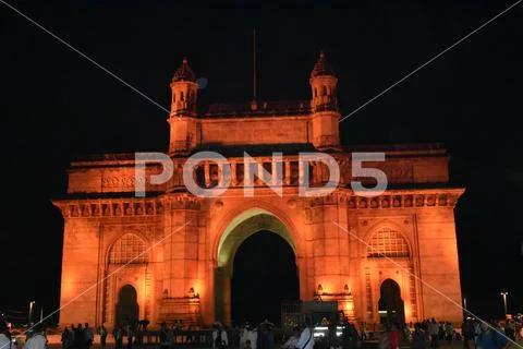 Glowing brown light on Gateway of india in Mumbai Stock Photos