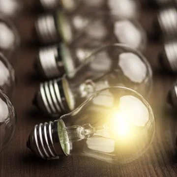 Glowing bulb uniqueness concept Stock Photos
