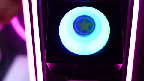 Glowing button with multi-colored neon lights and a star in the center Stock Footage 323010854